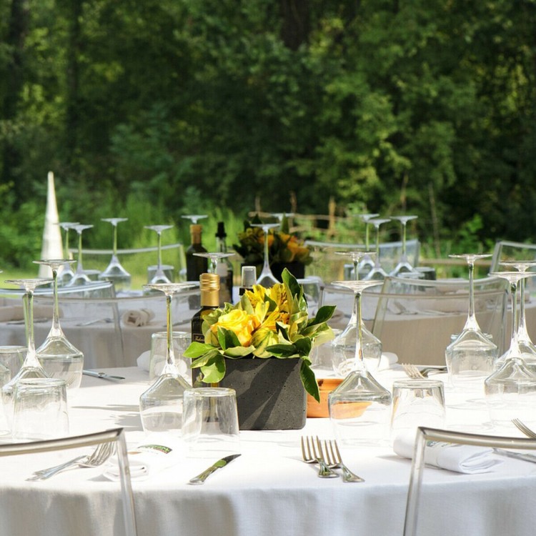 White 90-inch round tablecloth made of durable polyester, elegantly covering a table for dining or events.